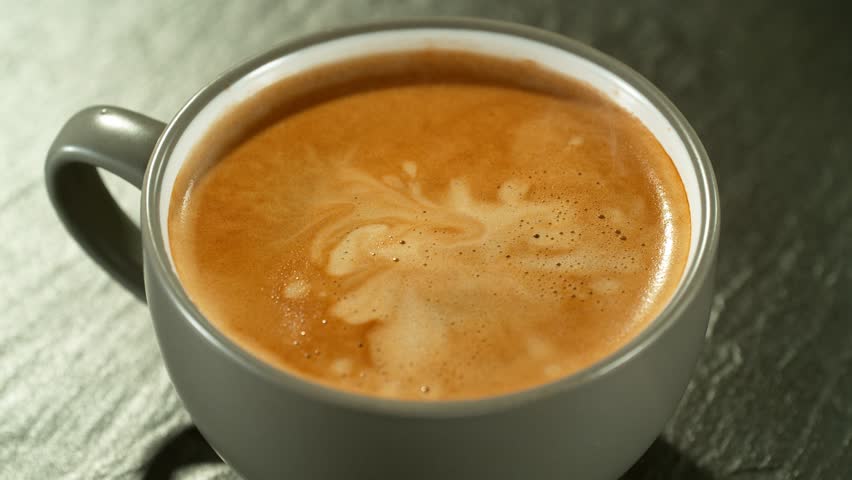 Super slow motion of falling drop into coffee with camera motion. Filmed on high speed cinema camera, 1000fps placed on high speed cine bot.