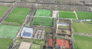 aerial drone video of amateur sports and recreation in The Netherlands. Sport clubs and fields, accomodation and facilities, soccer, tennis, american football.