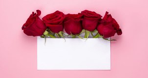 Trendy video banner for Valentines Day, International Women's Day or mothers day. Party or wedding invitation. Red rose flowers arrangement with blank card, on light pink background. Copy space