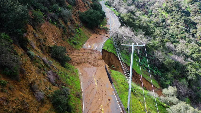 Drone flying over a earthslip, blocked highland road in California, United States