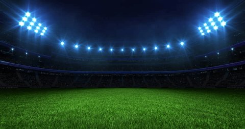 Sports background with a stadium at night with glowing spotlights. Camera flying over grass field. Professional 4K video loop for sports advertisement. : vidéo de stock