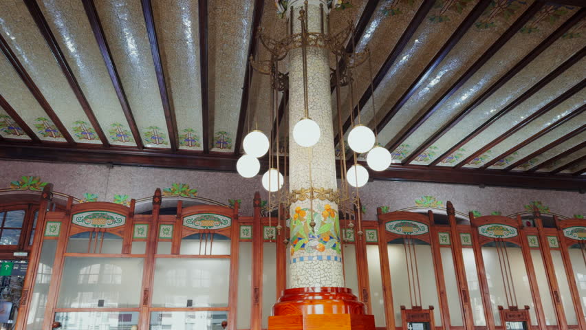 Column with modernist decoration lights inside the Nord train station in Valencia, Spain.