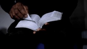 man praying with bible with black background with people stock video stock footage
