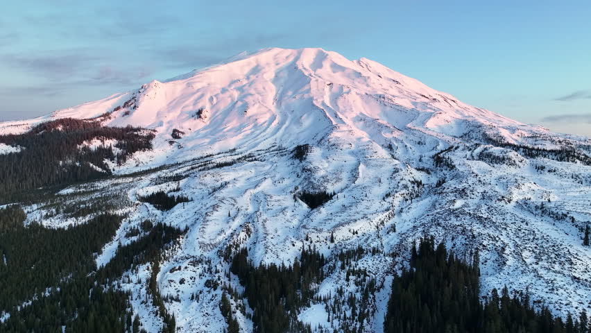 Dawn illuminates Mount St. Helens, not far from both Seattle and Portland, as it rises from the forested landscape in Washington. This active and scenic stratovolcano last erupted on May 18, 1980.
