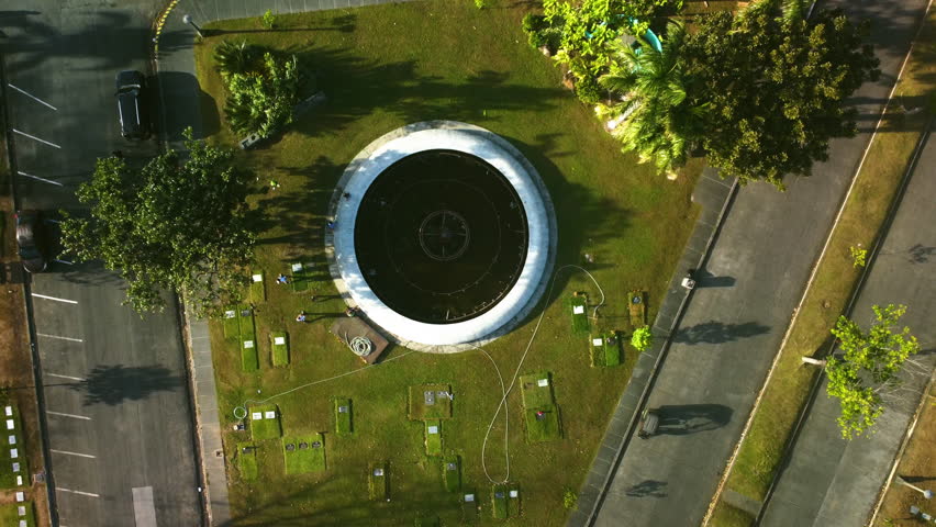 Top down drone shot above the MMP Fountain in Manila memorial park, sunny Philippines