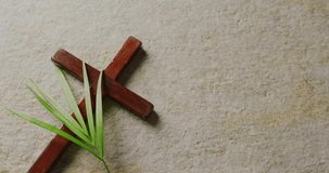 Animation of holy saturday text over cross and palm on grey background. Easter, tradition and celebration concept digitally generated video.