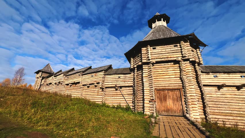 The scenery for the film The Heart of Parma in the Perm region. A large log fortress in the open air in the golden autumn. Autumn panoramic view of the fortress in the rays of the sun.