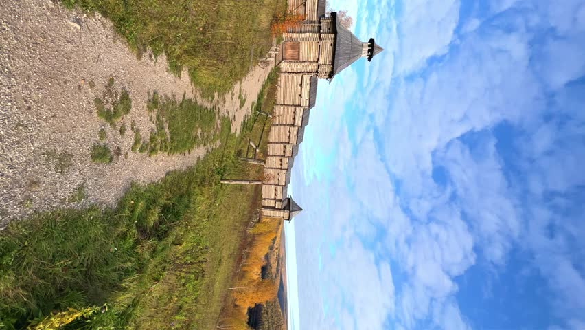 The scenery for the film The Heart of Parma in the Perm region. A large log fortress in the open air in the golden autumn. Autumn panoramic view of the fortress in the rays of the sun.