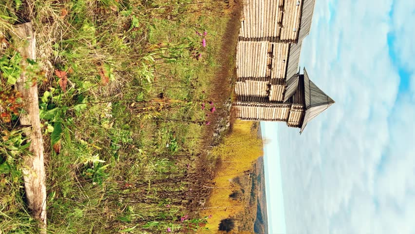 The scenery for the film The Heart of Parma in the Perm region. A large log fortress in the open air in the golden autumn. Autumn panoramic view of the fortress in the rays of the sun.