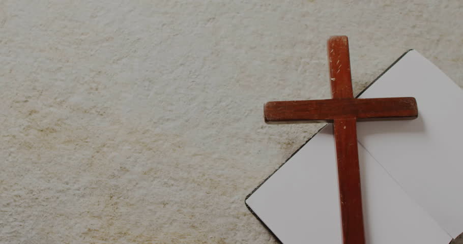 Animation of easter sunday text over christian cross and book on grey background. Easter, religion, christianity, tradition and celebration concept digitally generated video. Royalty-Free Stock Footage #3447634587