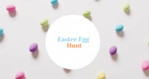 Animation of easter egg hunt text over colourful easter eggs on white background. Easter, religion, christianity, tradition and celebration concept digitally generated video.