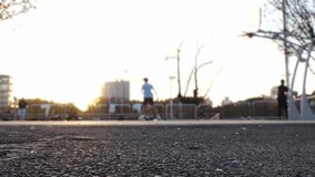 TOKYO, JAPAN : View of unidentified young people playing BASKETBALL in the park. Shot in sunset time. Sports, fitness, exercise and health concept video.