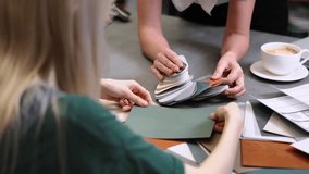 Close up hand choosing color from color sample swatch. The designer works with the customer and recommends the colors of decorative coatings. - Powered by Shutterstock - Get 15% off with code: PIKWIZARD15