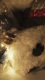 Christmas decorations, gifts and decorations in the dark, garlands in jars with a Christmas tree. Candle light. Slide shot Vertical video.
