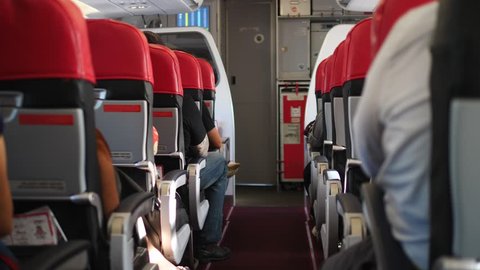 Interior Of Airplane With Passengers On Seats. 4K. 