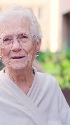 Tender old woman smiling at camera outside a nursing home Royalty-Free Stock Footage #3447781127