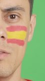 Man with a spanish flag painted on the face smiling