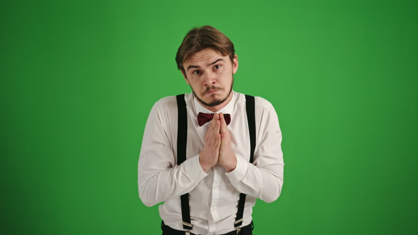Young Man Gesturing for a Small Request on Green Background
