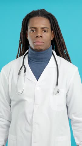 Latin male doctor with dreadlocks smiling with arms crossed Royalty-Free Stock Footage #3447808551