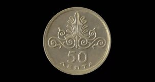 Reverse of Greece coin 50 lepta 1973, isolated in black background. Seamless animation in 4k resolution video.