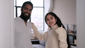 Friendly Couple Opens The Door Of The House And Invites In - Powered by Shutterstock - Get 15% off with code: PIKWIZARD15