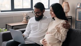 Pregnant Wife And Husband Using Laptop On Sofa In Living Room - Powered by Shutterstock - Get 15% off with code: PIKWIZARD15