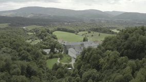 Royal Collegiate of Roncesvalles or Roncevaux and surrounding landscape, Navarre in Spain. Aerial forward