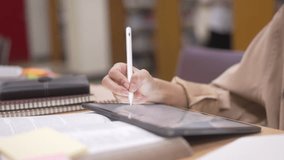 University student doing homework at library  - Powered by Shutterstock - Get 15% off with code: PIKWIZARD15
