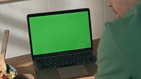 Unknown man hands typing keyboard greenscreen laptop at morning kitchen closeup. Young freelancer working remotely using chromakey computer at home. Guy writing messages emails reports online indoors  - Powered by Shutterstock - Get 15% off with code: PIKWIZARD15