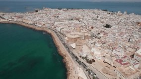 panoramic drone video panning movement of cadiz cathedral, Old Town and coastline during sunny day
