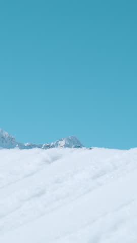SLOW MOTION, CLOSE UP Action shot of an expert freestyle skier taking off a kicker and doing a 360 grab while exploring , Slovenia. Skier riding in the mountains of Slovenia does a cool trick.
