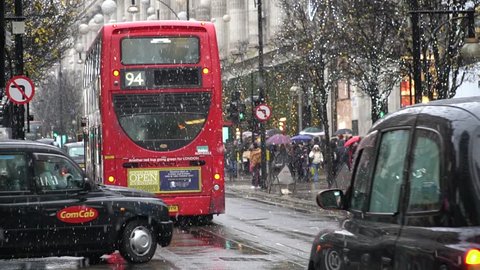 London,UK - 12-09-17: Routemaster is the one of Transportation in London. Red Bus and Black Cab in snow day at central London around Oxford street.