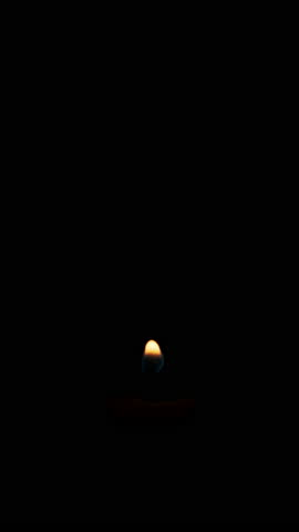 Vertical candle burns on a green background. Candle flame on chroma key. Copy space. Fire flame candlelight close-up. Alpha channel background. Isolated. Concept holiday party, religious, memories 4K