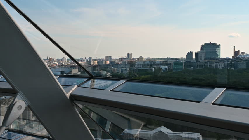 Berlin, Germany, August 15, 2023. POV footage from inside the glass and metal dome located on the roof of the Reichstag building: the fluttering flag of united Europe stands out. Beautiful summer day.