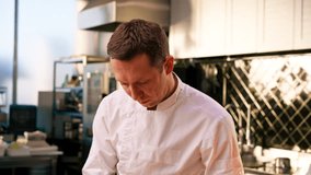 close-up of the face of a chef preparing dishes in a professional kitchen - Powered by Shutterstock - Get 15% off with code: PIKWIZARD15