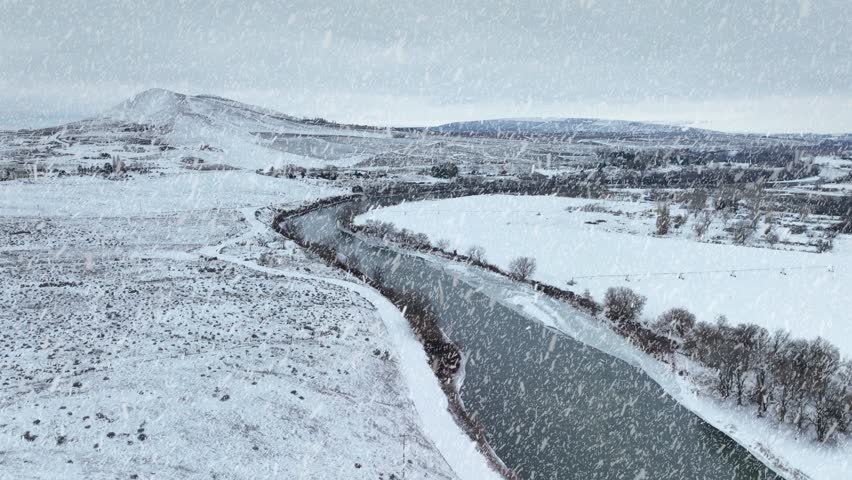 Snow falling on rural Eastern Washington, Yakima River. Royalty-Free Stock Footage #3448282393