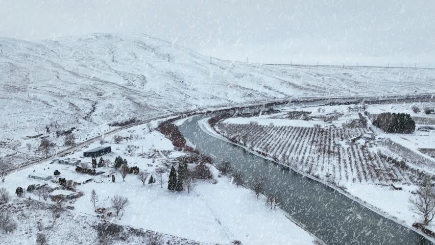 Snow falling on the Yakima River in Eastern Washington. Royalty-Free Stock Footage #3448282765