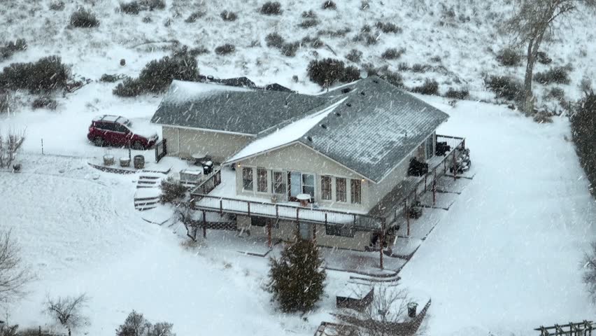 Snow falling on isolated cabin in Washington State.