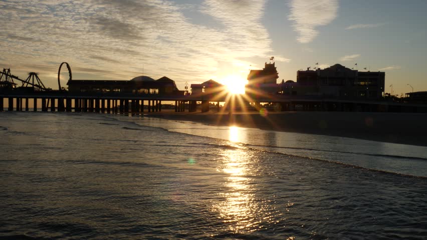 Galveston Pier Silhouette Sunset Behind with Sparkling Waves in Sun