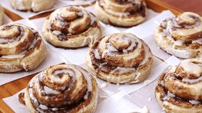 Sugar glazed cinnamon buns on parchment paper - Powered by Shutterstock - Get 15% off with code: PIKWIZARD15