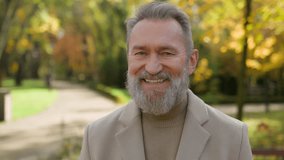 Portrait senior Caucasian male intelligent 60s old man happy retired bearded grandpa in city park satisfied joyful middle age gentleman looking at camera happiness emotion smile outdoors autumn nature - Powered by Shutterstock - Get 15% off with code: PIKWIZARD15