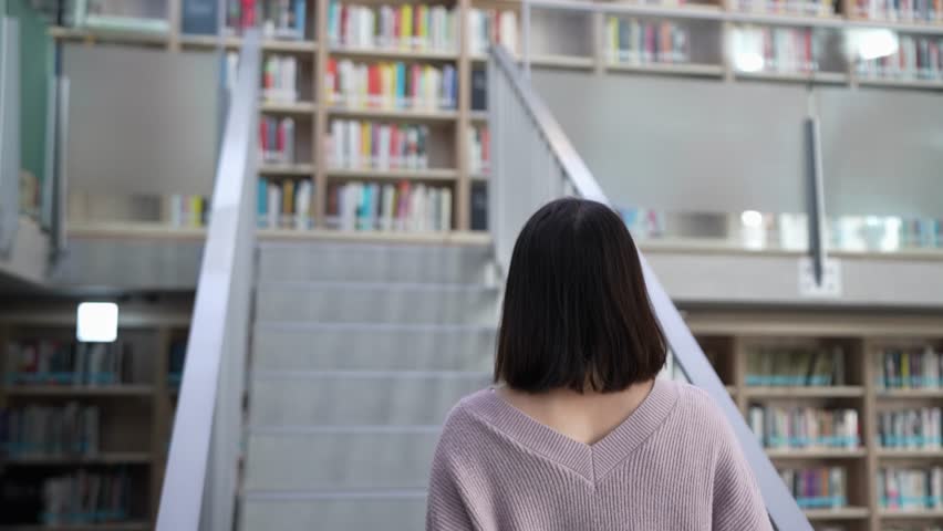 A 20-year-old Taiwanese female college student spending time at a beautiful library at a university in Wenshan District, Taipei City, Taiwan 