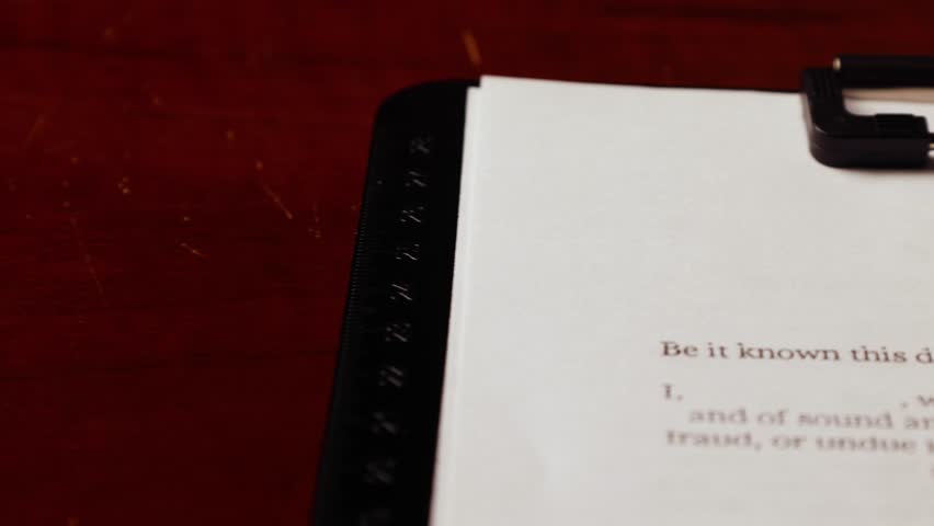 Dolly shot of will and testament important form document on table 2