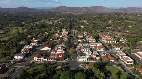 Afternoon aerial view of tree framed mission revival style architecture of historic downtown Rancho Santa Fe, California, USA.: film stockowy