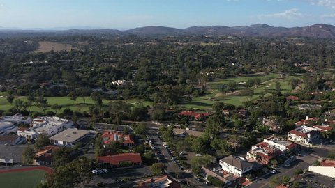 Afternoon aerial view of tree framed mission revival style architecture of historic downtown Rancho Santa Fe, California, USA.: film stockowy
