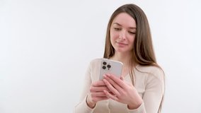 girl in hands of smartphone white phone girl smiling good news beautiful video interesting information social networks white background studio life on Internet 