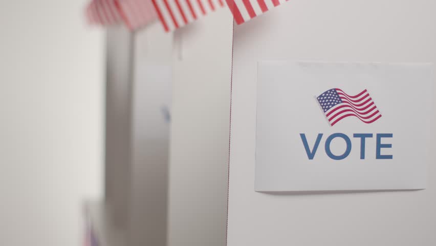 Close up of voters in booths with ballot papers casting votes in American election Royalty-Free Stock Footage #3448399385