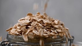 Oatmeal, oats flakes falling in a jar. Breakfast porridge. Macro shot - Powered by Shutterstock - Get 15% off with code: PIKWIZARD15