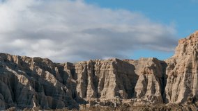 Flowing cloudscape over the unique topography of the cliffs at Red Rock Canyon State Park - time lapse - Powered by Shutterstock - Get 15% off with code: PIKWIZARD15