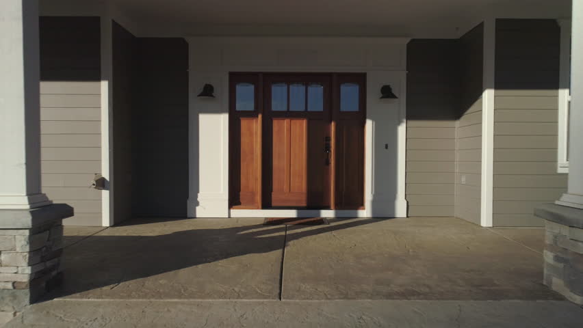 Beautiful new custom home, camera pulls out from front door to reveal house. Royalty-Free Stock Footage #34486822